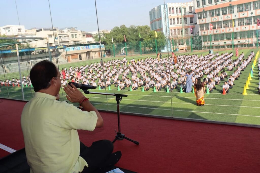 A Kaahe mentor leads a meditation for students session, seen from behind as school students meditate quietly in a calm classroom setting.